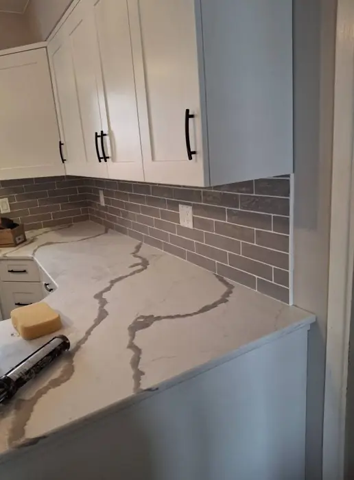 Grey subway tile backsplash by AVS Contracting